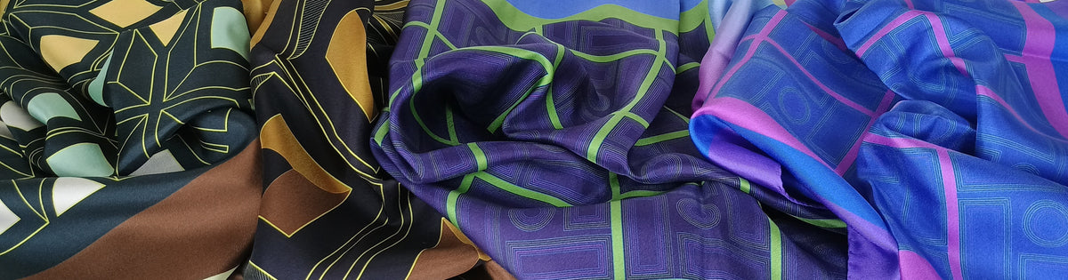 Close-up of colorful fabric with patterns and colors including purple, blue, green, and pink.